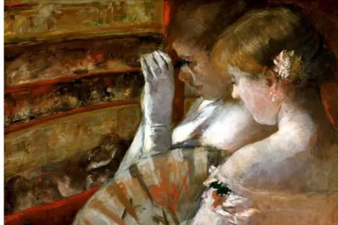 Two women in opera boxes, a classic scene from Mary Cassatt paintings, gaze out, one with a gloved hand to her face.