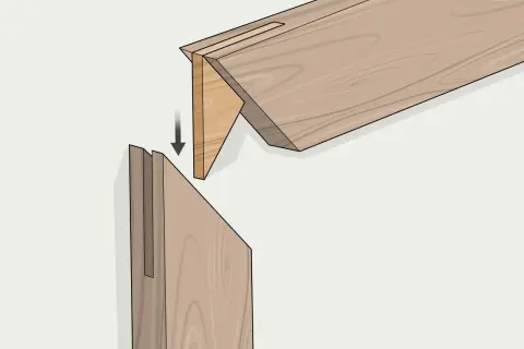 Ensamblaje de madera con un corte a inglete preciso, mostrando cómo encajan las piezas para formar una unión fuerte y limpia.