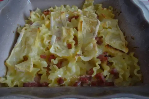 Un plat de pâtes gratinées au reblochon et lardons, prêt à être dégusté.