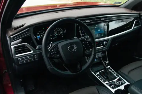 Wnętrze Ssangyong Korando, które często pojawia się w ssangyong korando - opinie użytkowników. Widoczna kierownica, ekran multimediów i panel sterowania.