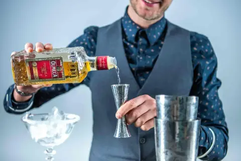 Barman nalewa Olmeca Tequila Gold do shakera. Z czego jest tequila? Z agawy!