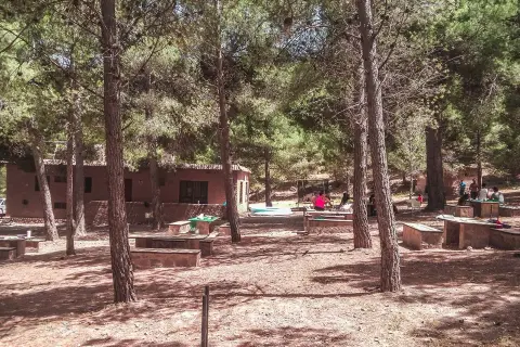 Un día de campo en Enix, con mesas de piedra y gente disfrutando del bosque. ¡Mucho que ver y hacer!