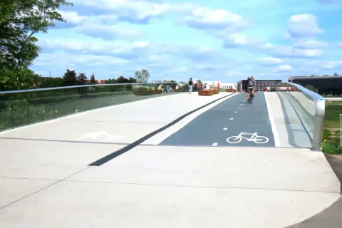 Nowy mostek rowerowy w lasku Marcelińskim z wyznaczonymi ścieżkami i ławkami.