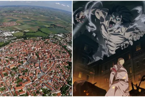 Luftaufnahme einer Stadt mit roten Dächern und einem riesigen Titanen, der über Gebäude ragt. Hier spielt Attack on Titan.