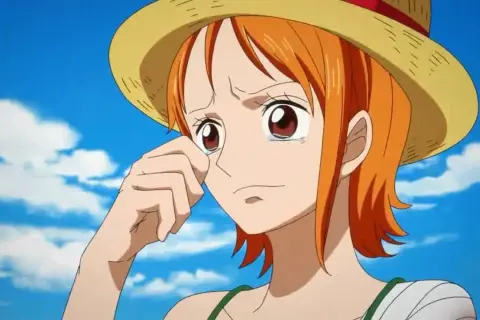 Nami One Piece weint unter ihrem Strohhut, die Hand am Auge. Ihr Arm ist bandagiert.