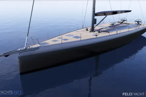 A sleek, modern sailboat with a dark hull and wooden deck glides on calm blue water.