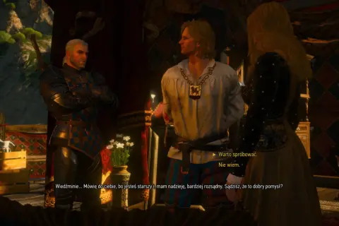 Geralt z Rivii w zbroi rozmawia z młodym mężczyzną i kobietą. W tle widać wnętrze karczmy w Wiedźmin 3.