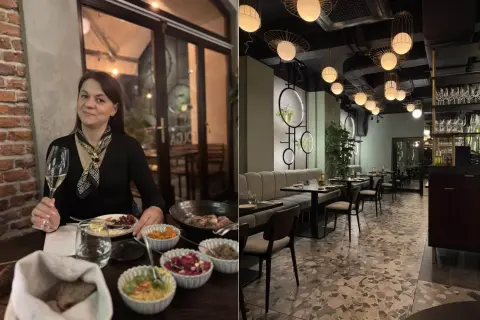 Kobieta z kieliszkiem wina w jednej z ciekawych restauracji okolic Krakowa. Wnętrze lokalu z nowoczesnym designem i stylowymi lampami.