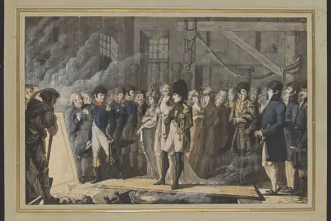 Napoléon, entouré de sa cour, examine un plan dans son cabinet de travail. L'ambiance est solennelle.