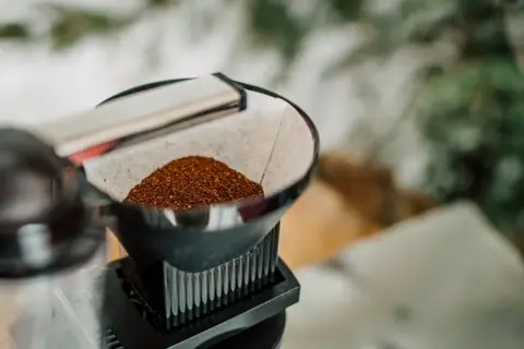 Färskt malet kaffe väntar i ett filter. Snart är det dags att koka kaffe och njuta av morgonen.