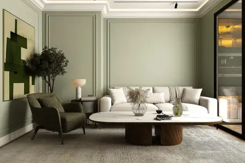 Ein stilvolles japandi style wohnzimmer mit einem beigen Sofa, einem grünen Sessel, einem ovalen Couchtisch und einem abstrakten Bild.