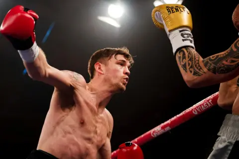 Sven Fornling i en intensiv boxningsmatch, med en röd handske höjd i luften.