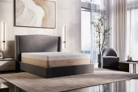 A Saatva memory foam mattress on a bed, showcasing its durability and comfort in a modern bedroom setting.