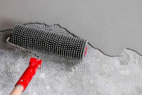 Rouleau débulleur sur ragréage frais. Le temps de séchage ragréage pour marcher dessus est bientôt terminé.
