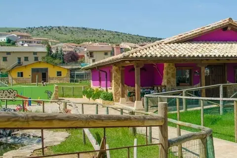 Un lugar ideal para rutas por Estella con niños: un parque infantil y una casa rural colorida.