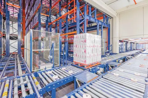 Automatyczny magazyn z systemem przenośników taśmowych i paletą towarów.