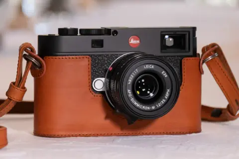 A Leica M camera in a brown leather case, with a Leica APO-Summicron-M 1:2/35 ASPH. lens. Are Leica cameras good? This one certainly looks the part.