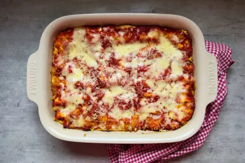 Frisch gebackene Lasagne im Auflaufform, bereit für das nächste lasagne rezept. Überbacken mit geschmolzenem Käse und Tomatensauce.