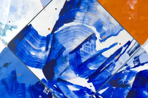 Vibrant contemporary abstract art with bold blue brushstrokes on white, accented by orange and light blue shapes.
