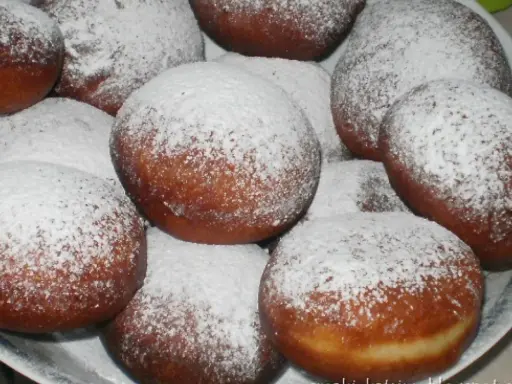 Pyszne, świeżo usmażone paczki posypane cukrem pudrem. Idealne, gdy zastanawiasz się, jak zrobić paczki na tłusty czwartek.