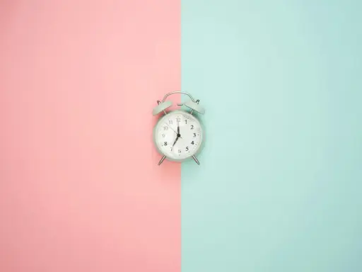 Budzik na pastelowym tle. Pokazuje 7:00, czas na rozpoczęcie dnia, czy to am, czy pm, zawsze jest dobry moment na zmianę.