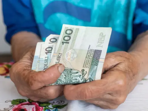 Dłonie trzymają polskie banknoty. Zastanawiasz się, ile może zająć ZUS z wynagrodzenia?