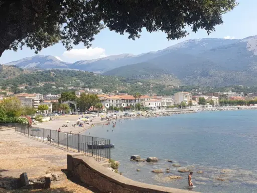 Vista panoramica di Sapri: una spiaggia affollata, il mare azzurro e le montagne sullo sfondo. Ecco cosa vedere a Sapri per una vacanza indimenticabile.