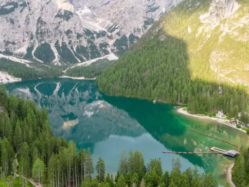 Un lago alpino dai riflessi smeraldo, incorniciato da boschi di conifere e montagne imponenti. Un gioiello tra i quattro laghi del nord Italia.