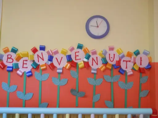 Fiori colorati con lettere formano la scritta "BENVENUTI", un'idea creativa per lavoretti di accoglienza.