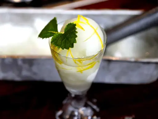 En läcker citronsorbet, perfekt för ett enkelt lubb recept. Garnerad med mynta och citronskal.
