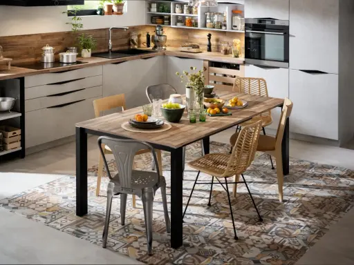 Tendance salle à manger avec chaises dépareillées : un mélange de style industriel et bohème autour d'une table en bois.