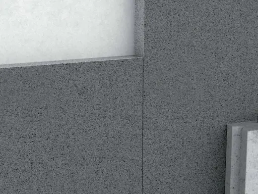 Detalle de un muro con hormigón aislante térmico, mostrando capas y textura granular.