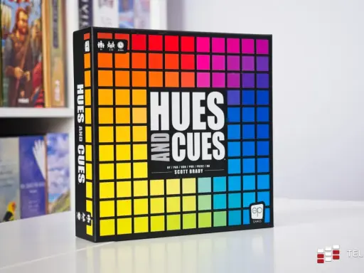 Gra planszowa "Hues and Cues" z tęczową paletą barw na okładce. Odkryj subtelne odcienie i wskazówki, by wygrać!
