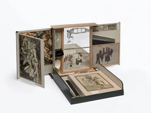 A surreal assemblage of famous drawers, featuring collage, mirrors, and found objects, creating a miniature world of artistic exploration.