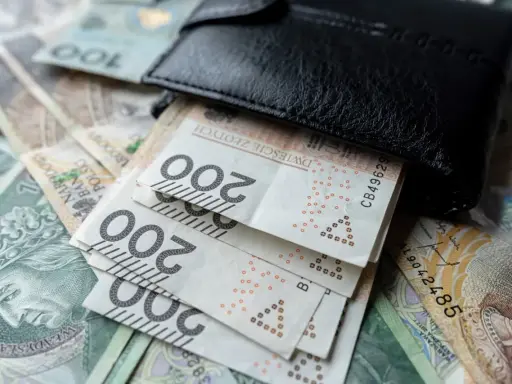 Portfel z banknotami 200 zł. Zastanawiasz się, ile wynosi dodatek do emerytury za warunki szkodliwe?