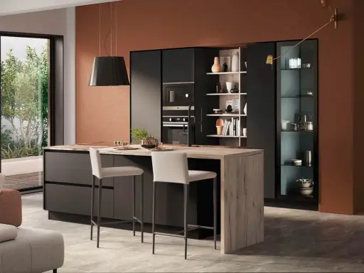Elegante zona giorno open space con cucina moderna, isola centrale in legno e soggiorno accogliente.