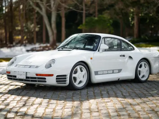 Weißer Porsche 959 S auf Kopfsteinpflaster. Ein Klassiker, dessen 959 Porsche Preis Kenner begeistert.