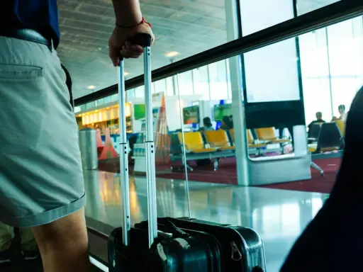 Osoba z walizką czeka na lot tunezyjskich linii lotniczych Nouvelair.