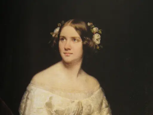 Porträtt av en ung kvinna med blommor i håret, kanske en ung Jenny Lind.