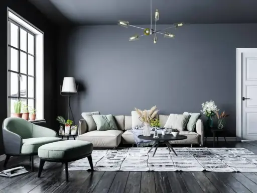 Nowoczesny salon z szarą ścianą, beżową kanapą i miętowym fotelem. Inspiracje kolory dla Twojego wnętrza.
