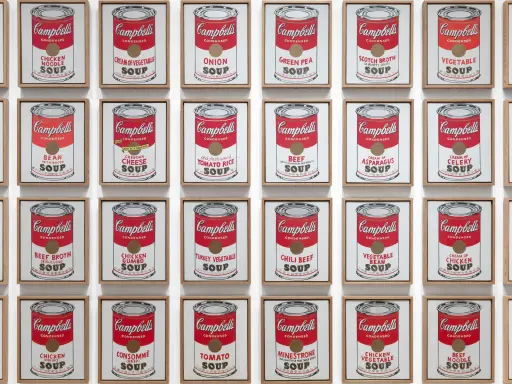Andy Warhol's repetition art showcases a grid of Campbell's soup cans, each a unique flavor, creating a vibrant pop art statement.