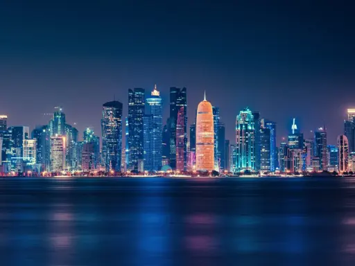 Glitzernde Skyline von Doha bei Nacht, ein Symbol für das moderne Katar.