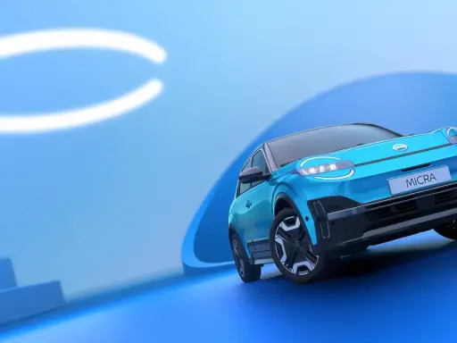 El Nissan Micra azul, con sus modernas luces y diseño, se presenta sobre un fondo abstracto. Conoce las medidas del Nissan Micra.