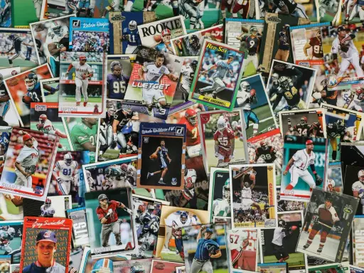 A colorful collage of sports trading cards, showcasing baseball, basketball, and football players. This collection could be part of an art consignment, where unique items are displayed and sold.