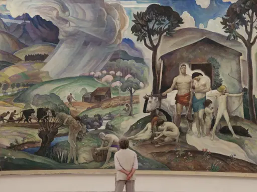 A mural depicting rural life and labor, reminiscent of the Wyeth family artists' style, with figures tending to livestock and fields under a dramatic sky.