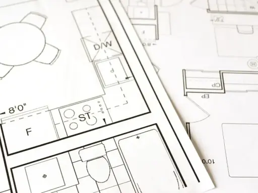 Plany architektoniczne pokazują, jak obliczyć metry kwadratowe pokoju, z zaznaczonymi wymiarami i elementami wyposażenia.