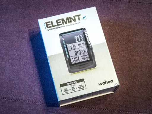 Pudełko z nawigacją rowerową Wahoo ELEMNT. Na ekranie urządzenia widoczne dane: prędkość, dystans, czas, kalorie i przewyższenie.