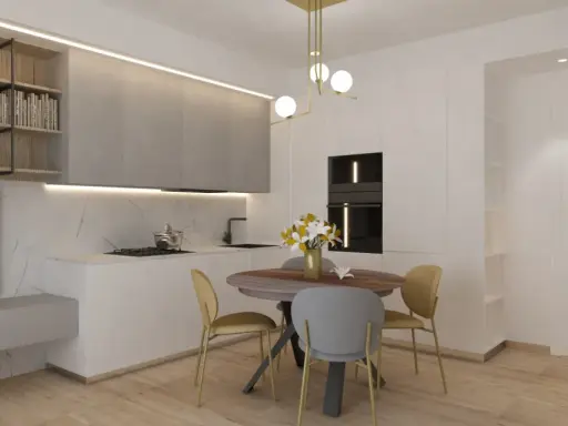 Ingresso su sala da pranzo con tavolo rotondo, sedie, cucina moderna e scaffali a muro.