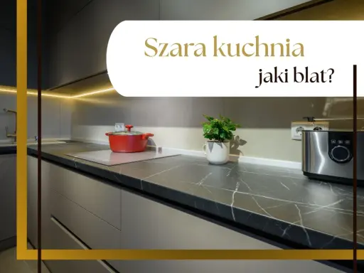 Nowoczesna szara kuchnia z ciemnym blatem, na którym stoi czerwony garnek i srebrny toster.