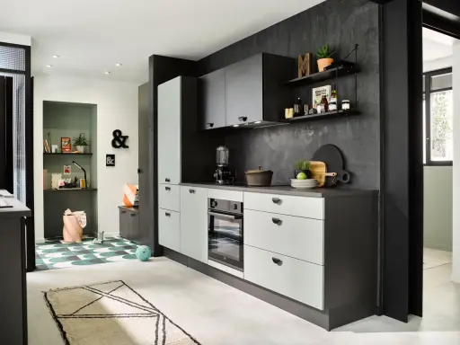 Cuisines vertes modernes avec murs texturés sombres, armoires claires et un coin bureau coloré.